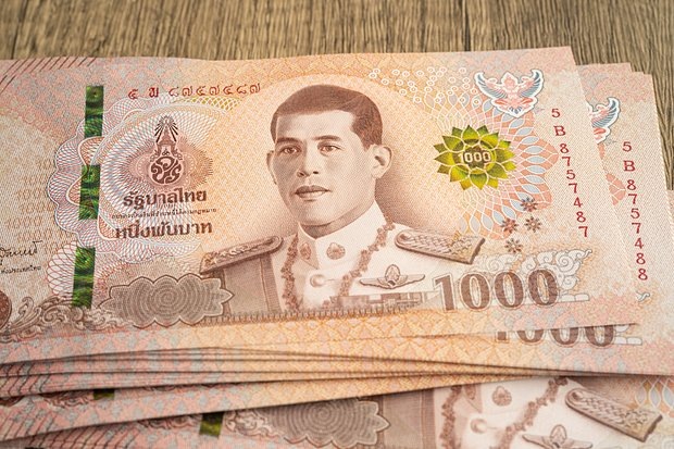    В Таиланде запрещено мять купюры, ронять их на землю и даже случайно наступать на них. Фото: surprisestock / Shutterstock / Fotodom