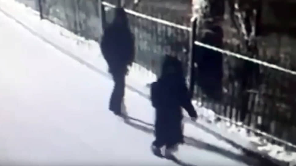 Кадр из записи камеры видеонаблюдения, на котором запечатлен похищенный подросток и неизвестный человек в капюшоне.📷Фото: Кадр из видео СК России