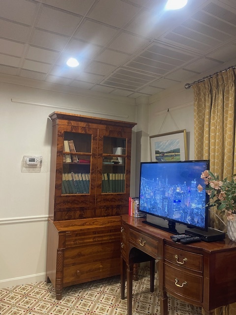 Витрина, шкаф и старинный стол, который работает как ТВ-зона