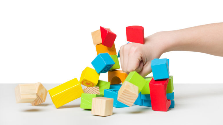    Hand beating house made of color wooden blocks