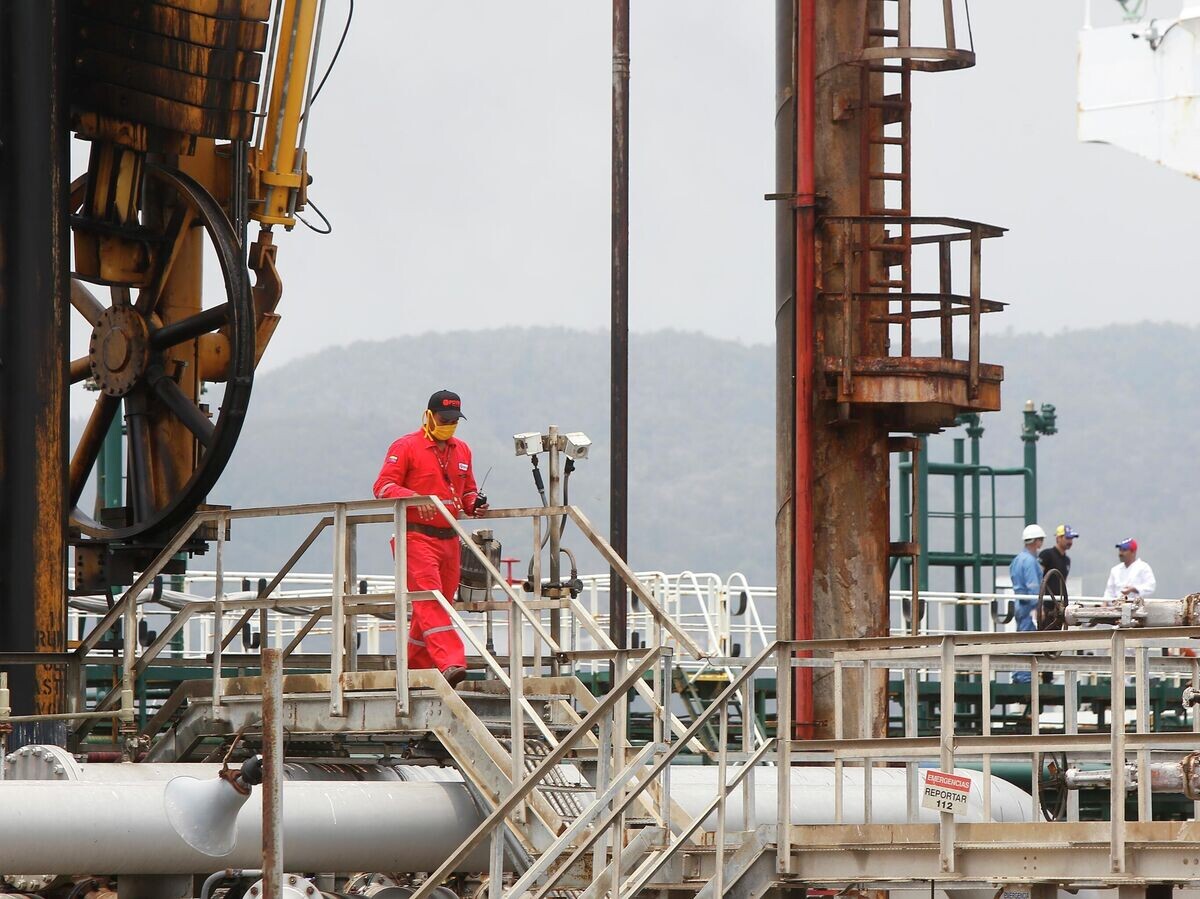    Венесуэльский нефтяник идет по нефтеперерабатывающему заводу Эль-Палито во время прибытия иранского нефтяного танкера Fortune возле Пуэрто-Кабельо, Венесуэла | © AP Photo / Ernesto Vargas