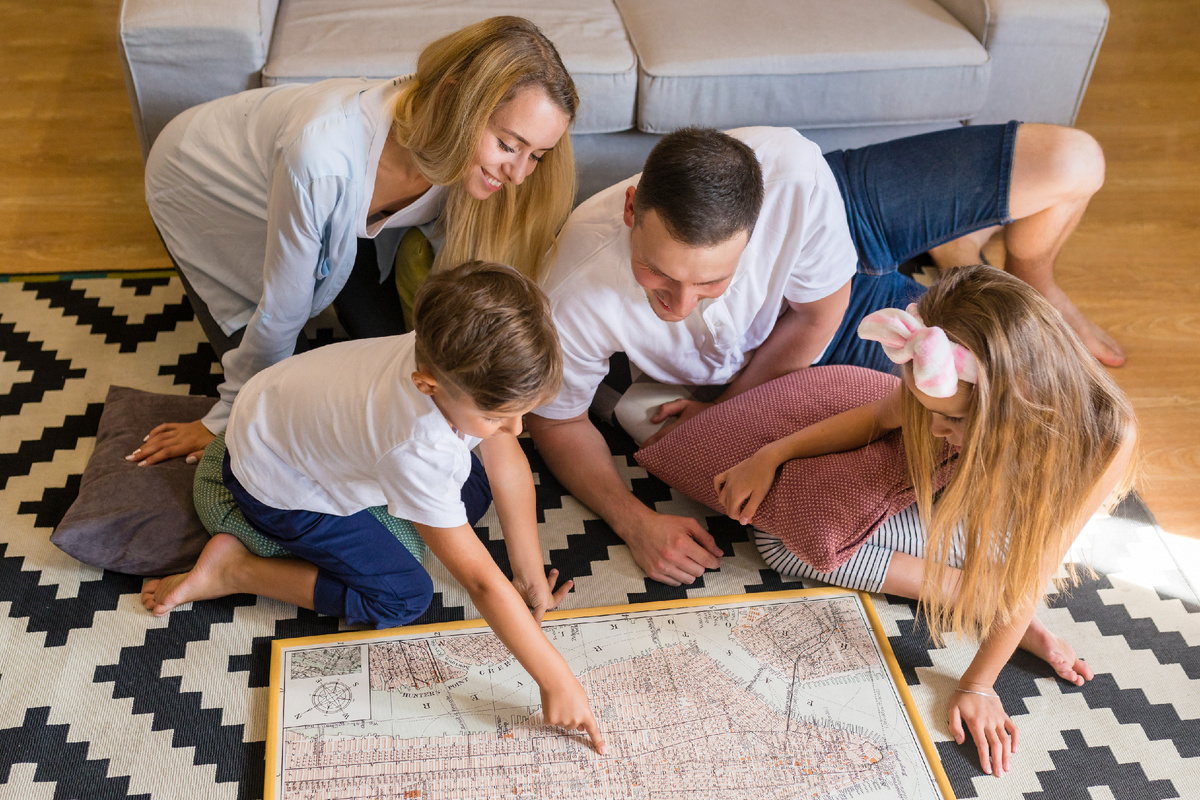 freepik.com/free-photo/high-view-family-looking-blue-print