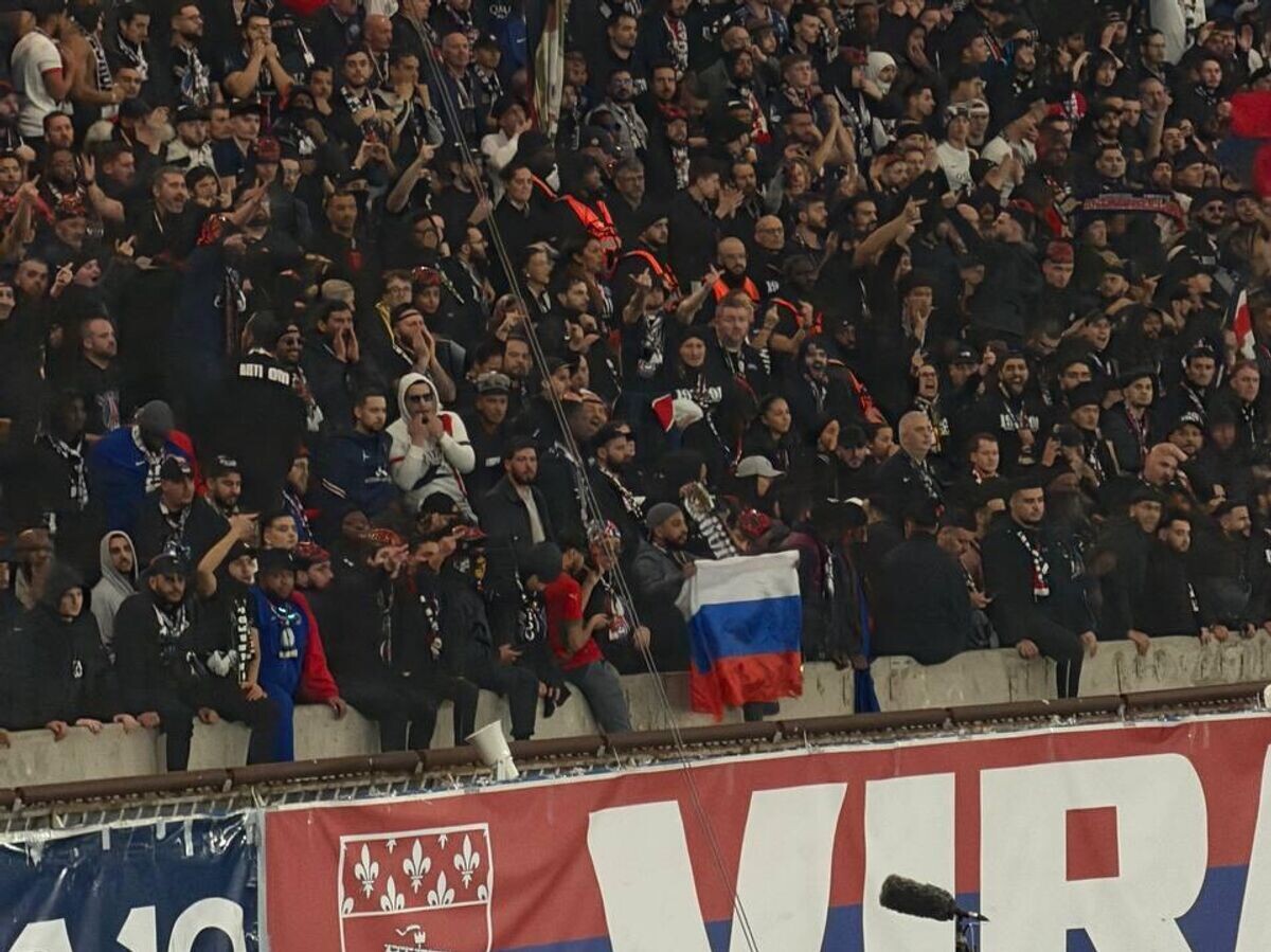    Флаг России на трибуне парижского стадиона "Парк де Пренс" во время матча между "ПСЖ" и "Марселем" в чемпионате Франции по футболу | © Фото : Telegram-канал супруги российского вратаря "ПСЖ" Матвея Сафонова Марины Кондратюк