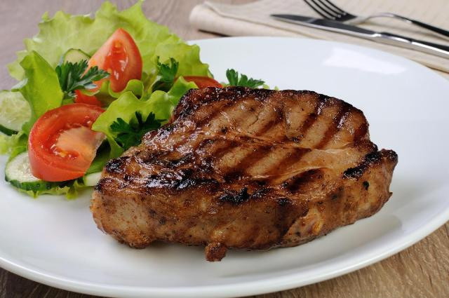    piece of juicy pork steak grilled with a salad