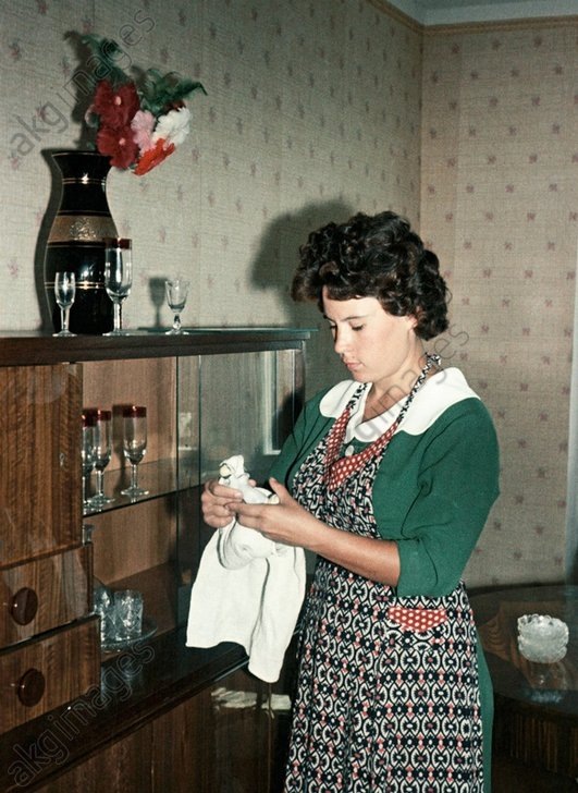 Жена космонавта  Германа Титова Тамара убирает квартиру, 1961 год