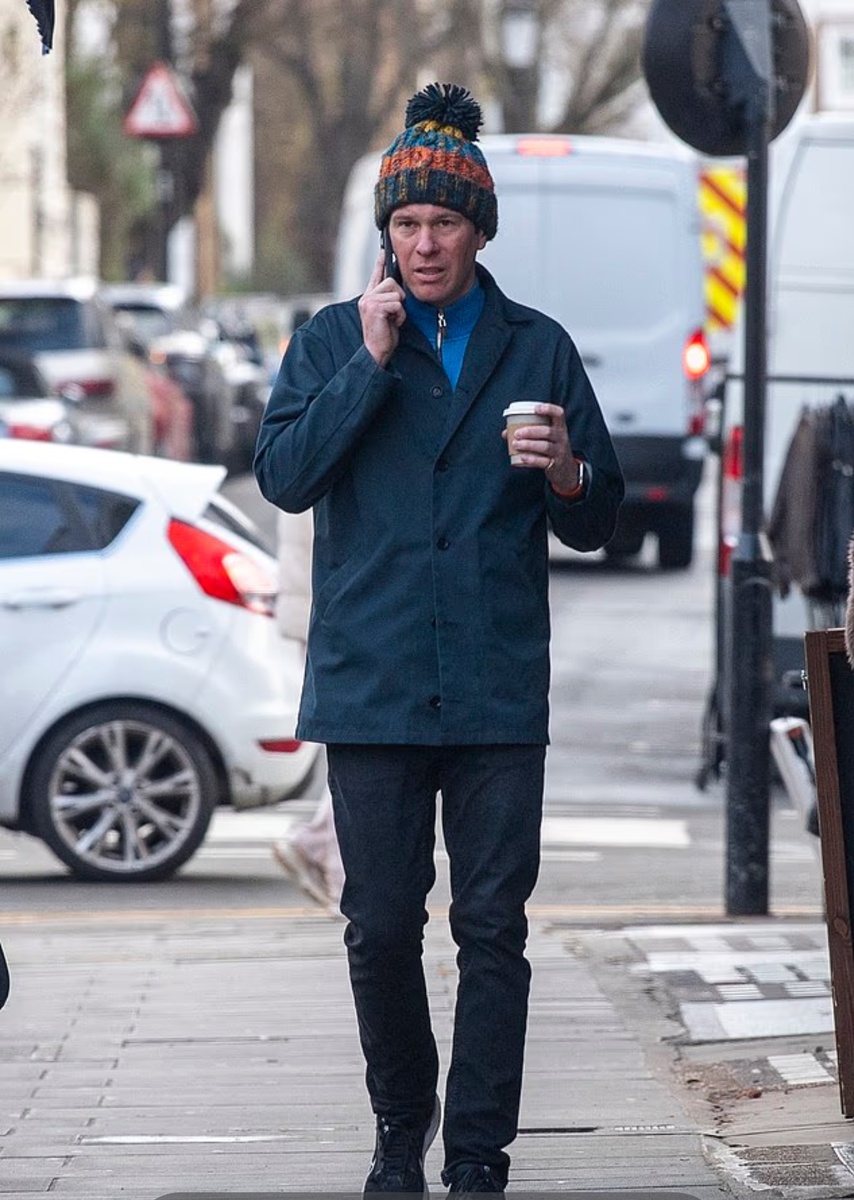 Джек Бруксбанк сегодня разговаривает по телефону в Ноттинг-Хилле в яркой шапке с помпоном.