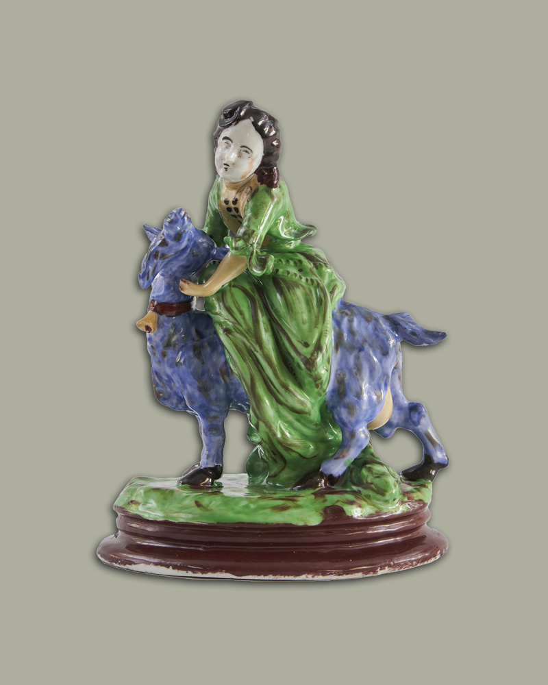 Барышня на голубой козе. Частные заводы Гжели. Середина XIX века. Галерея Умная коллекция. Изделие доступно к просмотру и приобретению.