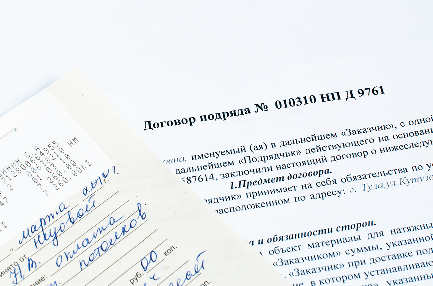 Договор подряда и оплаченная квитанция на столе