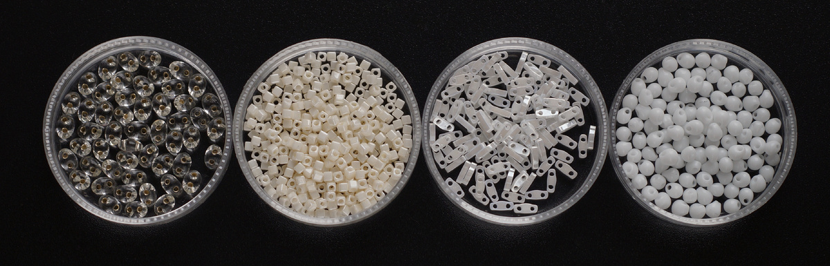 Небольшое разнообразие форм бисера из моих запасов. Слева направо - Preciosa Twin (бисер с двумя отверстиями), TOHO Cube (бисер кубической формы), Miyuki Quarter TILA (четверть плоской плитки с двумя отверстиями), Miyuki Drops (бисер в виде небольшой капли со смещенным центром)