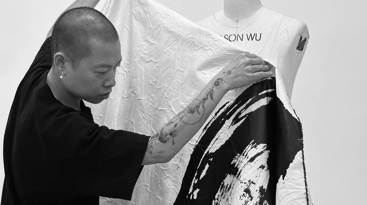 Jason Wu draping a garment from his spring 2025 collection, wwd.com