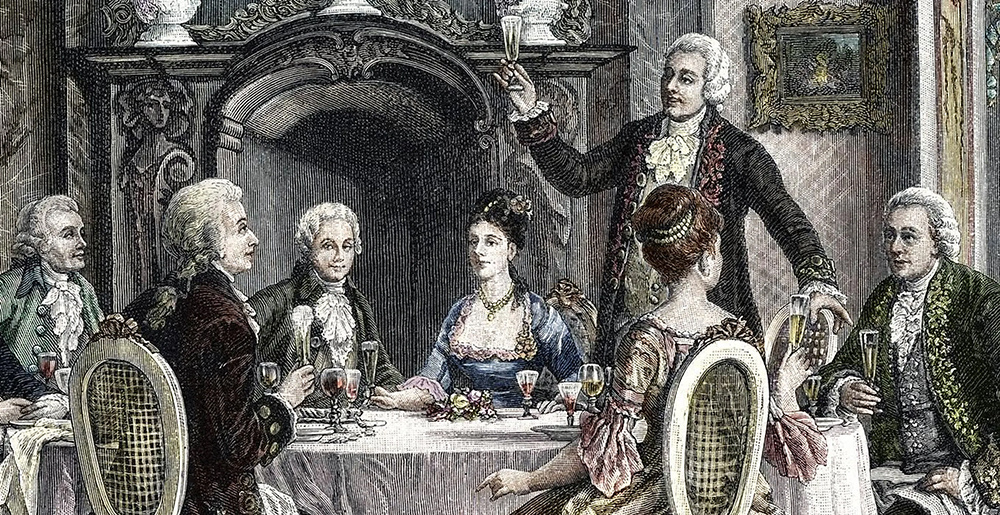 Ужин с шампанским в доме актера Эмануэля Шиканедера для Вольфганга Амадея Моцарта (второй слева) и Антонио Сальери (второй справа), гравюра XIX века © Leemage/Corbis via Getty Images