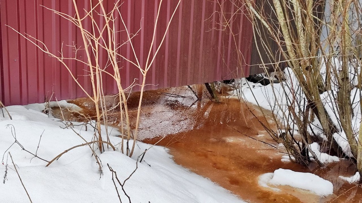 Вода стоит над льдом в канаве, перед ледовым затором.