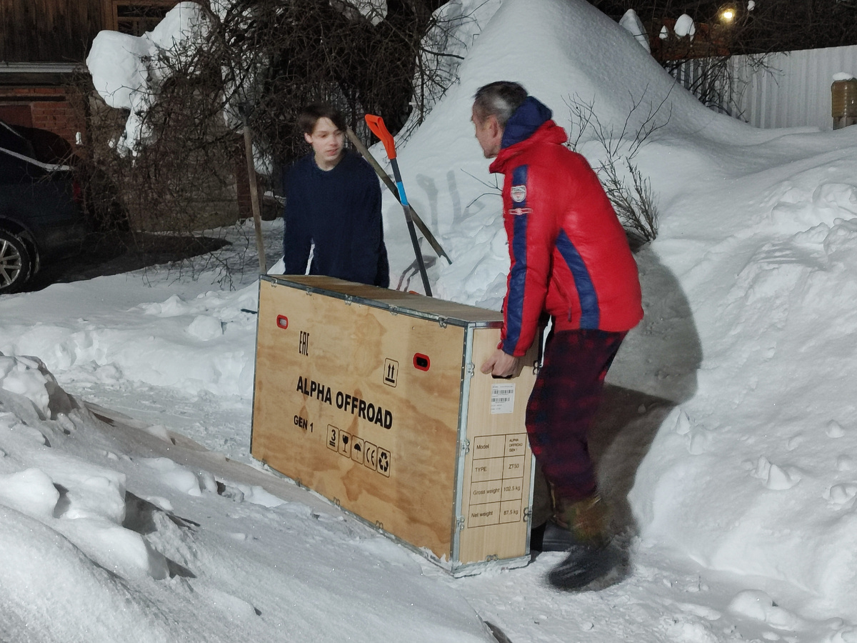 Фото автора, мальчики тащат мотоцикл в дом. 