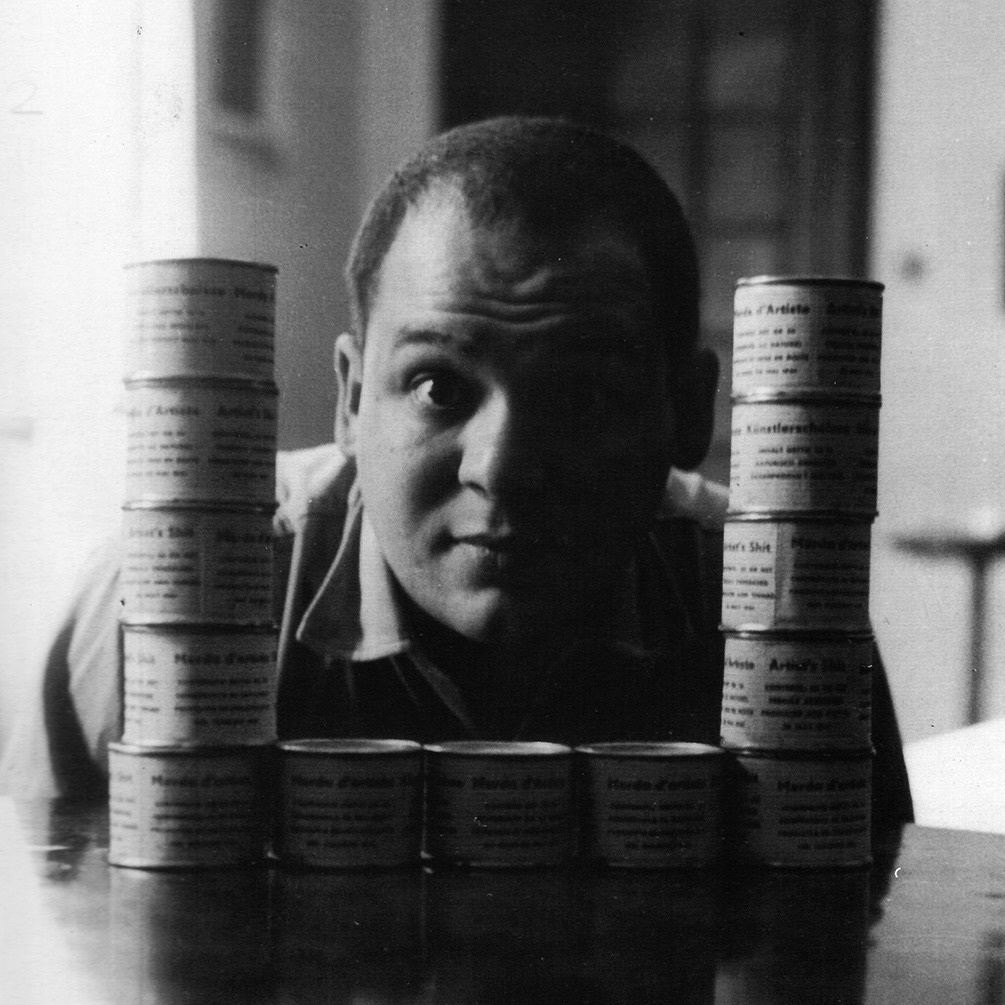 Piero Manzoni with some cans of Merda d'artista (Artist's Shit) in his apartment on Via Cernaia, Milan,1961