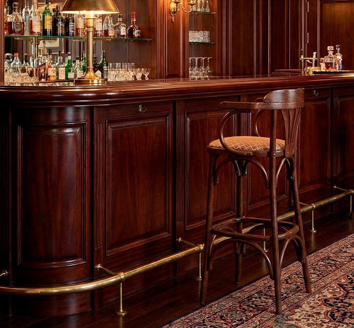 Тот же барный стул, помещенный в стильный интерьер дорогого бара с помощью генеративной нейросети. Идеальное совпадение света и теней.