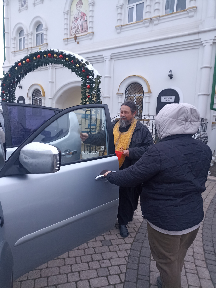 Отец Георгий освящает машину с "гуманитаркой" и благославляет в путь.
