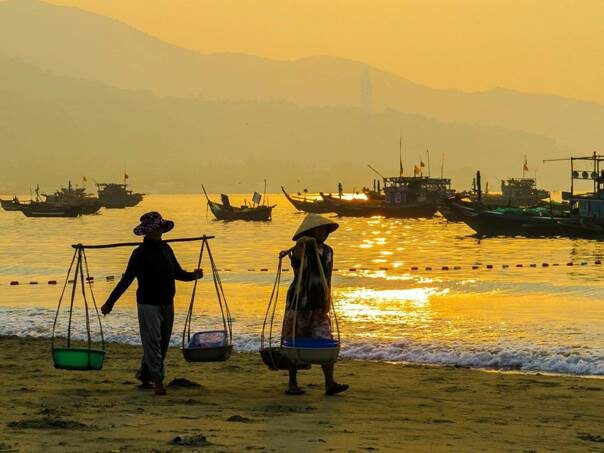 My Khe Beach at sunrise with a few colorful basket boats in the foreground