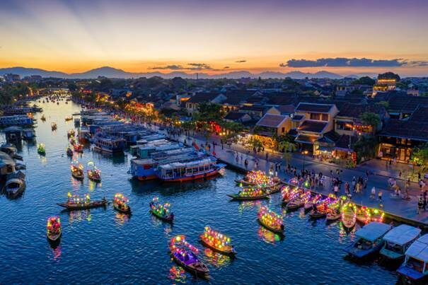 Close-up of hundreds of colorful lanterns reflecting on the river Thu Bon.