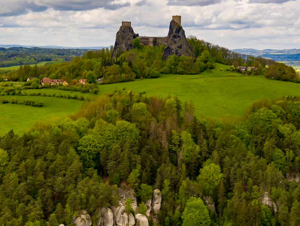 Этот вид наглядно объясняет, почему замок веками считался неприступным. Расположенные на отвесных базальтовых скалах башни позволяли контролировать всю округу на десятки километров вокруг. Сегодня это самая узнаваемая панорама северной Чехии.
