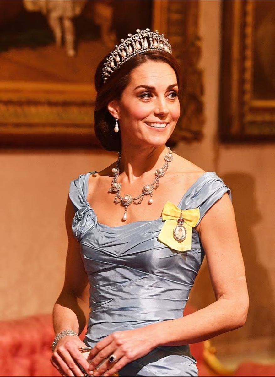 С тех пор как Кейт впервые надела бриллиантовую и жемчужную тиару в 2015 году, она быстро стала любимой украшением принцессы; за 10 лет она надевала это королевское украшение 14 раз. На этом снимке она запечатлена в этой фамильной реликвии во время государственного визита короля Нидерландов Виллема-Александра и королевы Максимы в 2018 году.