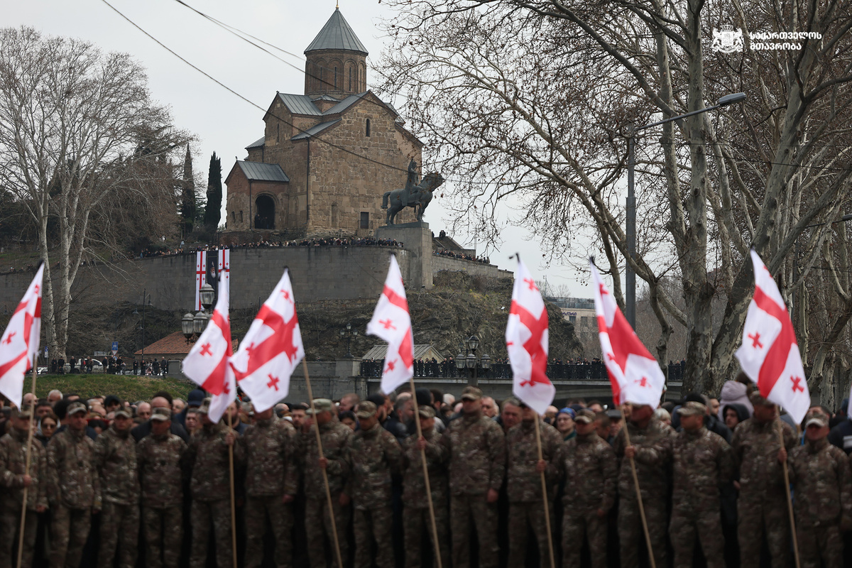Грузинские военные с флагами страны на фоне собора Сиони, 22 марта 2026г. Тбилиси.