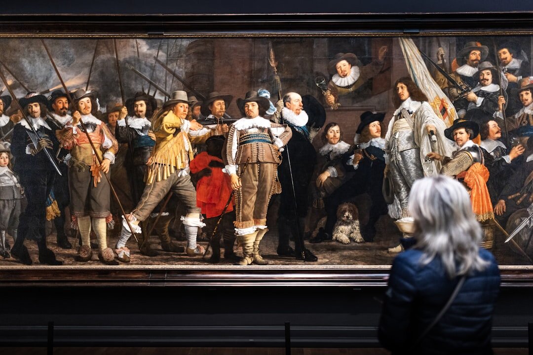 People admiring art in museum at Rijksmuseum in Amsterdam