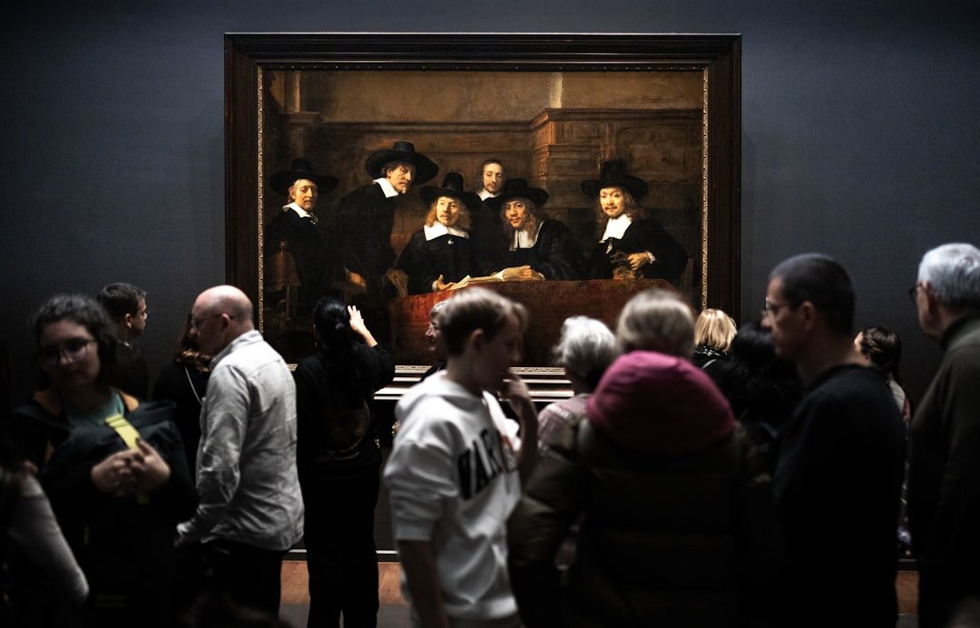 People admiring art in museum at Rijksmuseum in Amsterdam