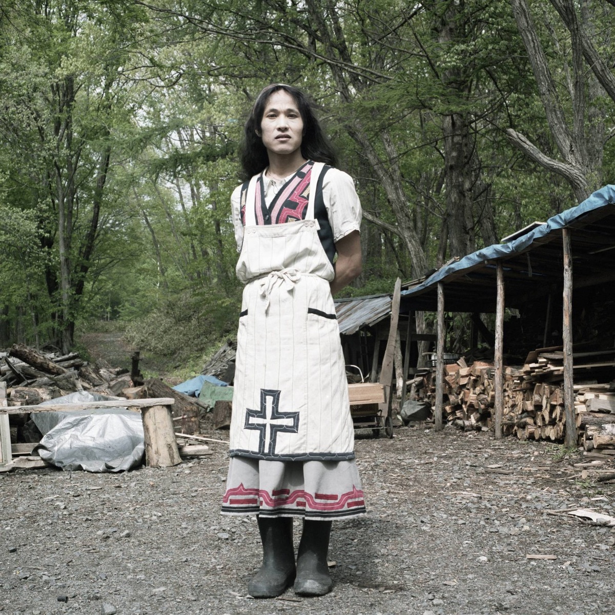 Заимствованная культура: Хотя Мадзи и не является айну по крови, она приняла местный образ жизни и уже многие годы живёт в коммуне Нибутани. Она владеет традиционной вышивкой, которую использует и в своей одежде, сделанной вручную, а также выращивает растения в горах неподалёку от своего дома, где и была сфотографирована.