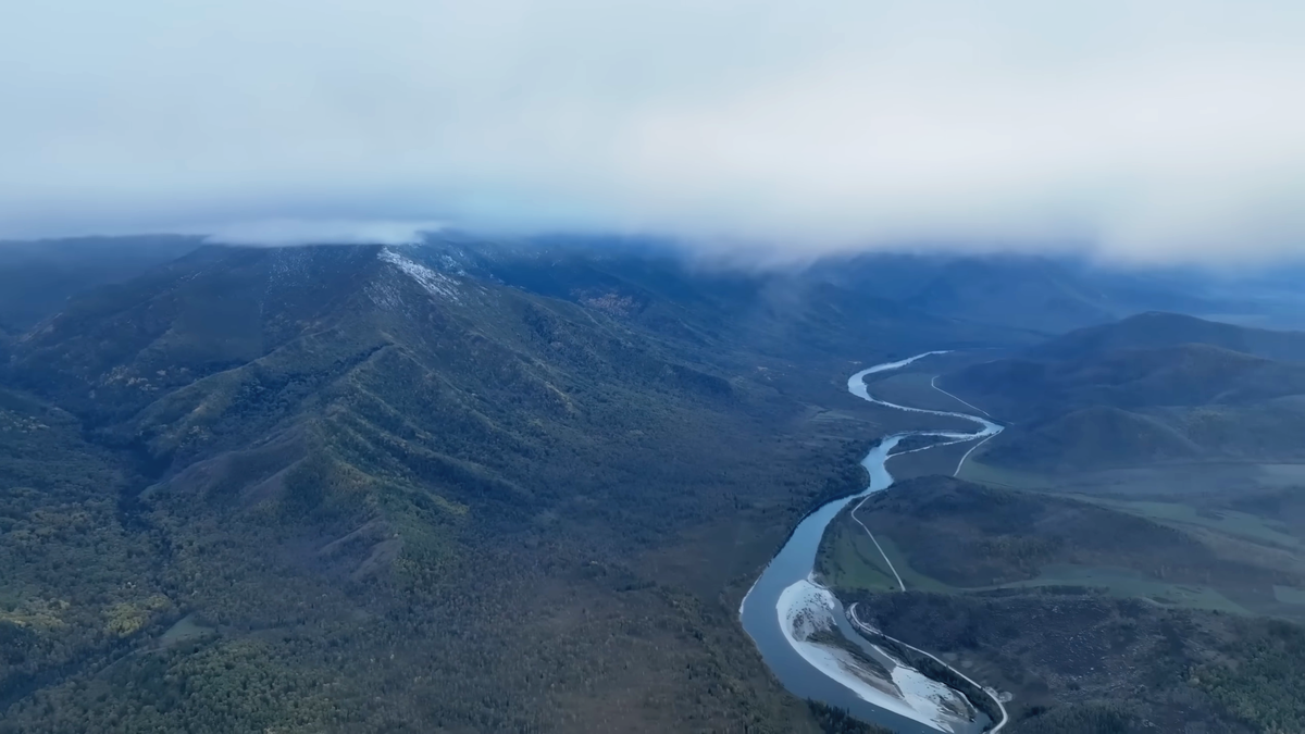 Панорамный вид на долину реки Катунь и горные хребты Алтая под облаками