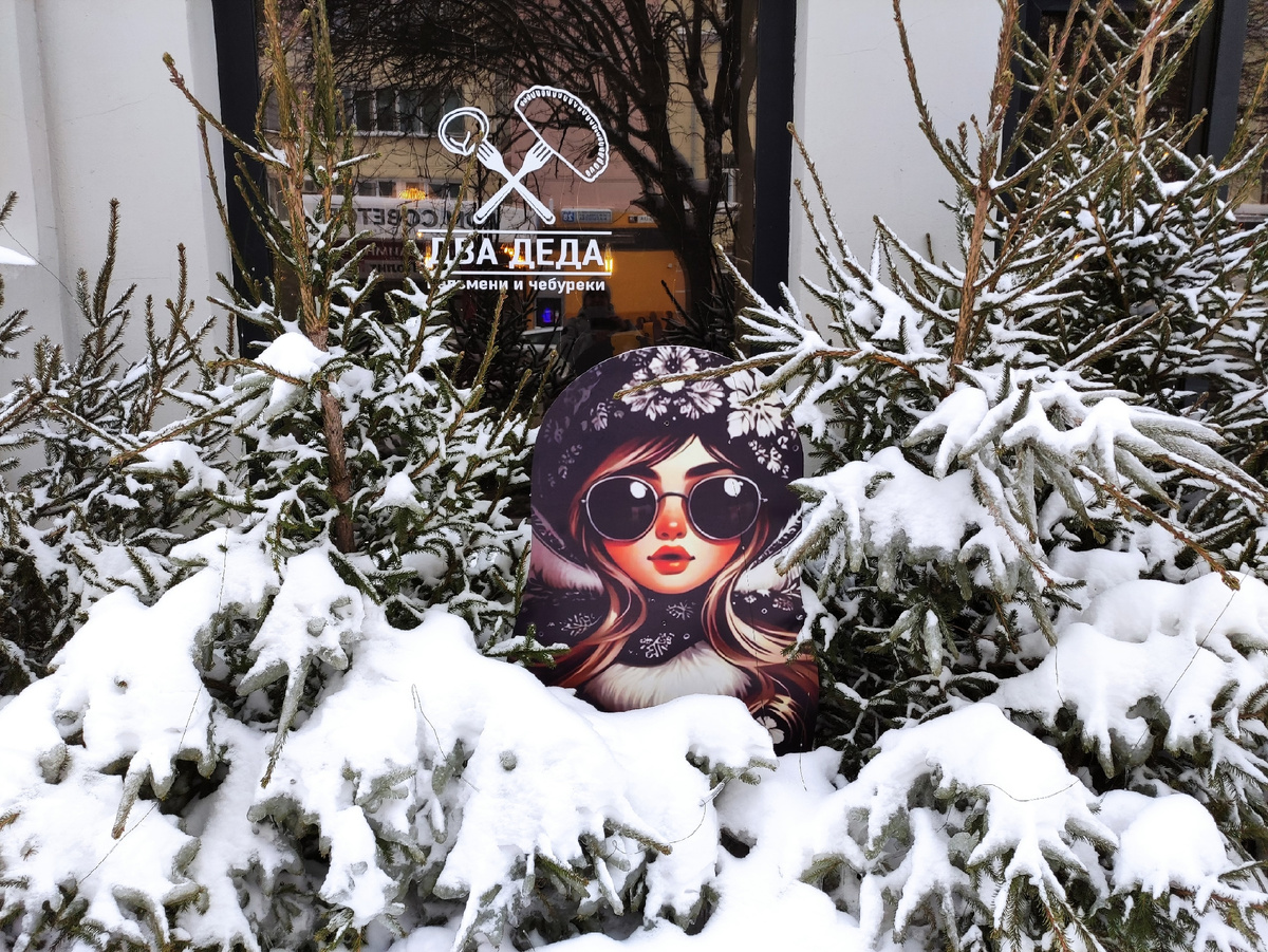 Правда ведь настоящая красотка спряталась среди заснеженных елей перед баром «ДВА ДЕДА» на улице Малышева, 27.  Фото сделано в начале марта 2026 года, когда вокруг ещё лежал снег.