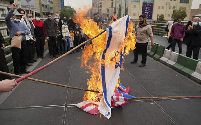    Demonstrators burn representations of Israeli, British and U.S. flags during the annual pro-Palestinians Al-Quds, or Jerusalem, Day rally in Tehran, Iran, Friday, April 29, 2022. Iran does not recognize Israel and supports Hamas and Hezbollah, militant groups that oppose it. (AP Photo/Vahid Salemi)