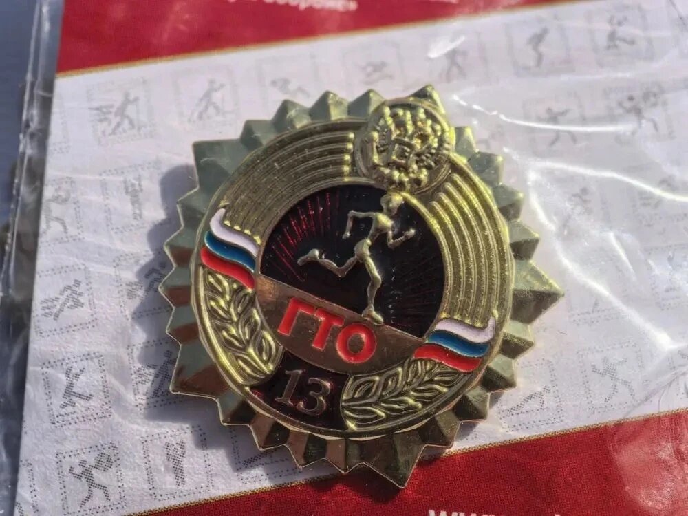 Напомним: комплекс «Готов к труду и обороне» был основан в СССР в 1931 году и возрождён указом Президента России в 2014 году.
Золотой значок — высшая награда, которая требует выполнения самых сложных нормативов в своей возрастной группе (всего их 18 — от 6 до 70+ лет).
Нормативы включают бег, подтягивания, отжимания, наклон и прыжки.