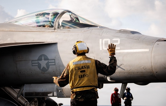    AT SEA - MARCH 02: (EDITOR’S NOTE: This Handout image was provided by a third-party organization and may not adhere to Getty Images’ editorial policy.) In this handout photo provided by the U.S. Navy, A U.S. Sailor signals to an F/A-18E Super Hornet aircraft, attached to Strike Fighter Squadron 37, on the flight deck of the world's largest aircraft carrier, USS Gerald R. Ford (CVN 78), while operating in support of Operation Epic Fury on March 2, 2026 in the Mediterranean Sea. (Photo by U.S. Navy via Getty Images) Nare