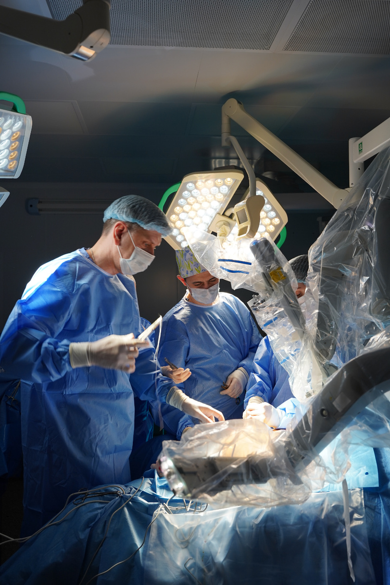 Директор Клиники Факультетской хирургии им. Н.Н.Бурденко, д.м.н., проф. Федор Петрович Ветшев и доцент Кафедры Факультетской хирургии №1, к.м.н. Ильдар Равильевич Билялов в ходе робот-ассистированной операции осуществляют докинг роботической консоли. Сеченовский Университет. Фото из личного архива.