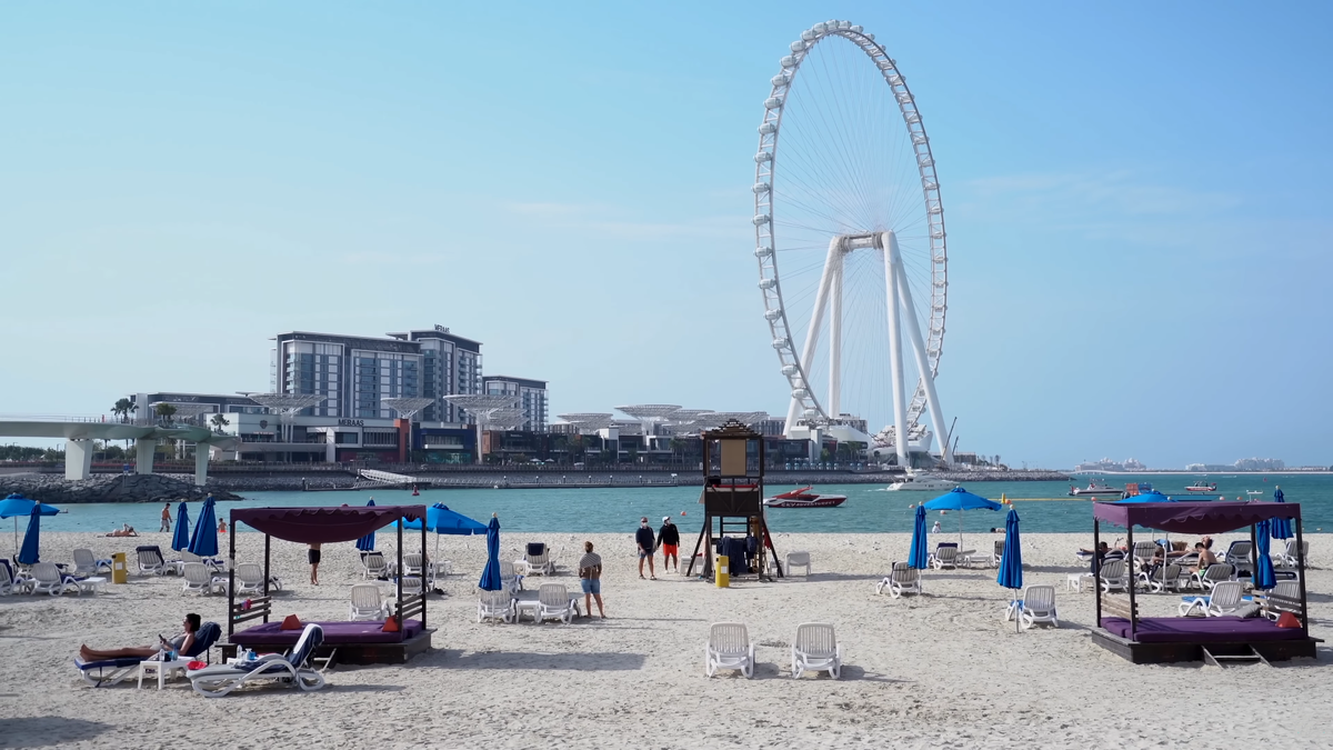 Пляжная линия, белый песок и гигантское колесо обозрения