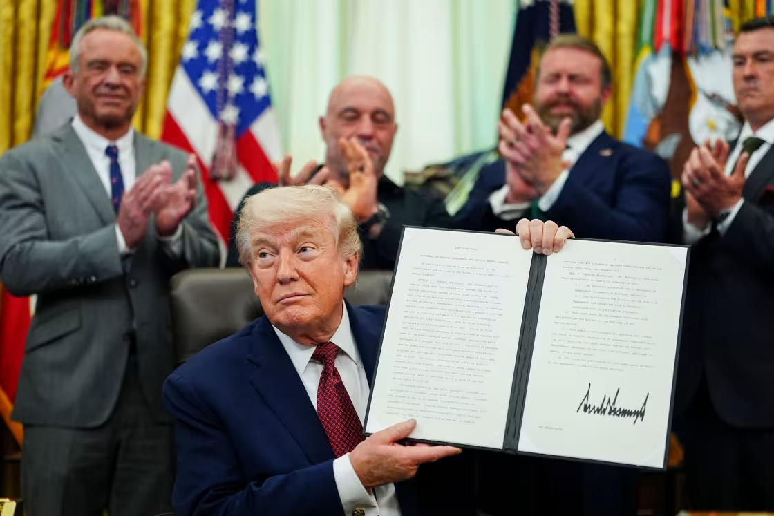 Президент Дональд Трамп держит в руках подписанный указ в Овальном кабинете Белого дома, суббота, 18 апреля 2026 года.