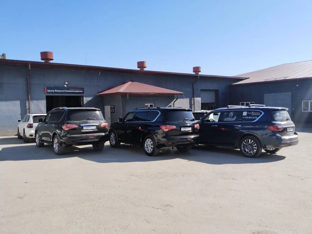 Общий план трёх Infiniti у въезда в сервис.