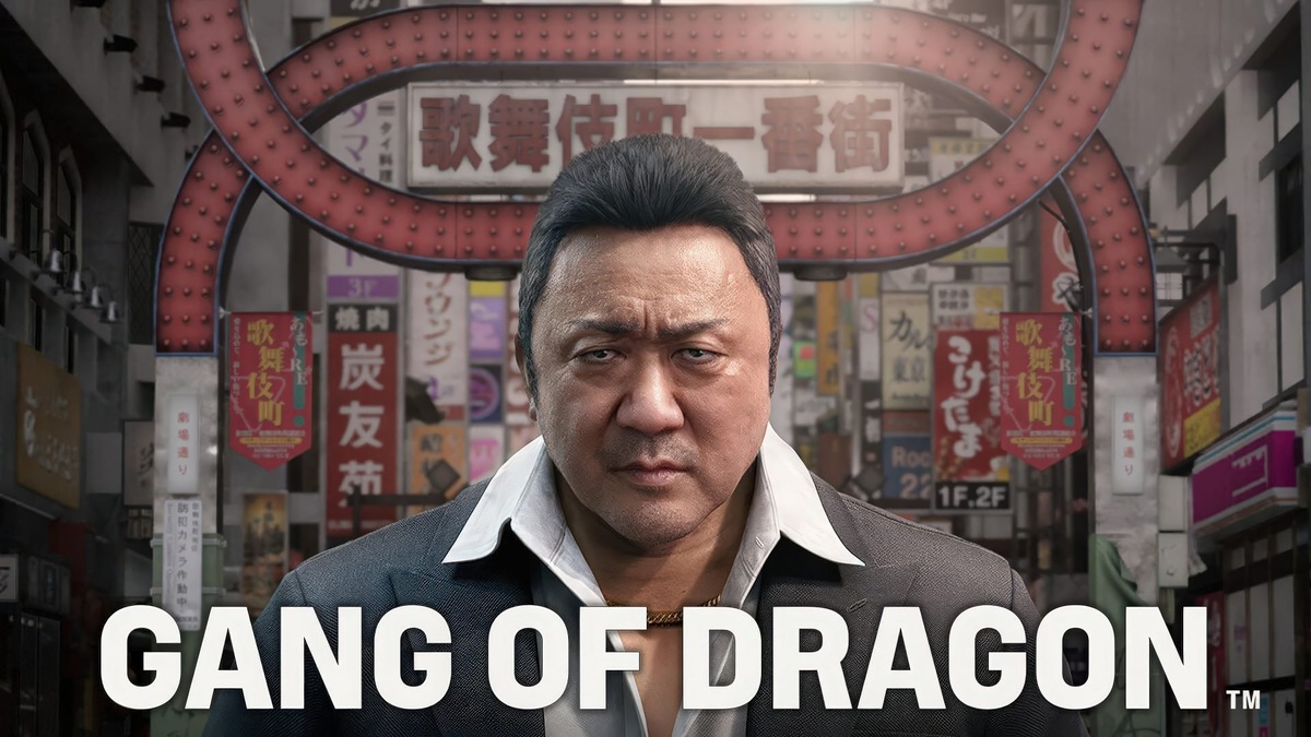    Close-up of a stern man in a suit in front of a busy Asian street with colorful posters and neon signs; large 'GANG OF DRAGON' text at the bottom.