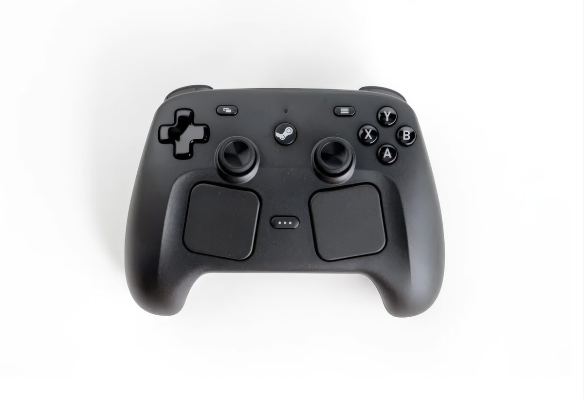    Top view of a black game controller with two analog sticks, a D-pad on the left, and A/B/X/Y buttons on the right; includes a center Steam/menu button.