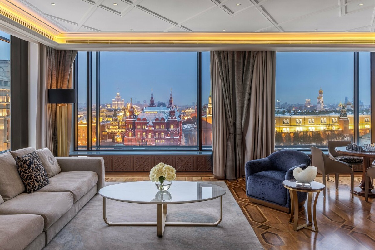Панорамный вид на Красную площадь и Кремль из люкса отеля The Carlton, Moscow 5* на улице Тверской, 3. Отель расположен в самом начале главной улицы столицы, в шаге от Манежной площади. В 2026 году это по-прежнему одна из самых эксклюзивных локаций Москвы для тех, кто ищет безупречный сервис, исторический контекст и лучшие виды на центр города прямо из гостиной.
