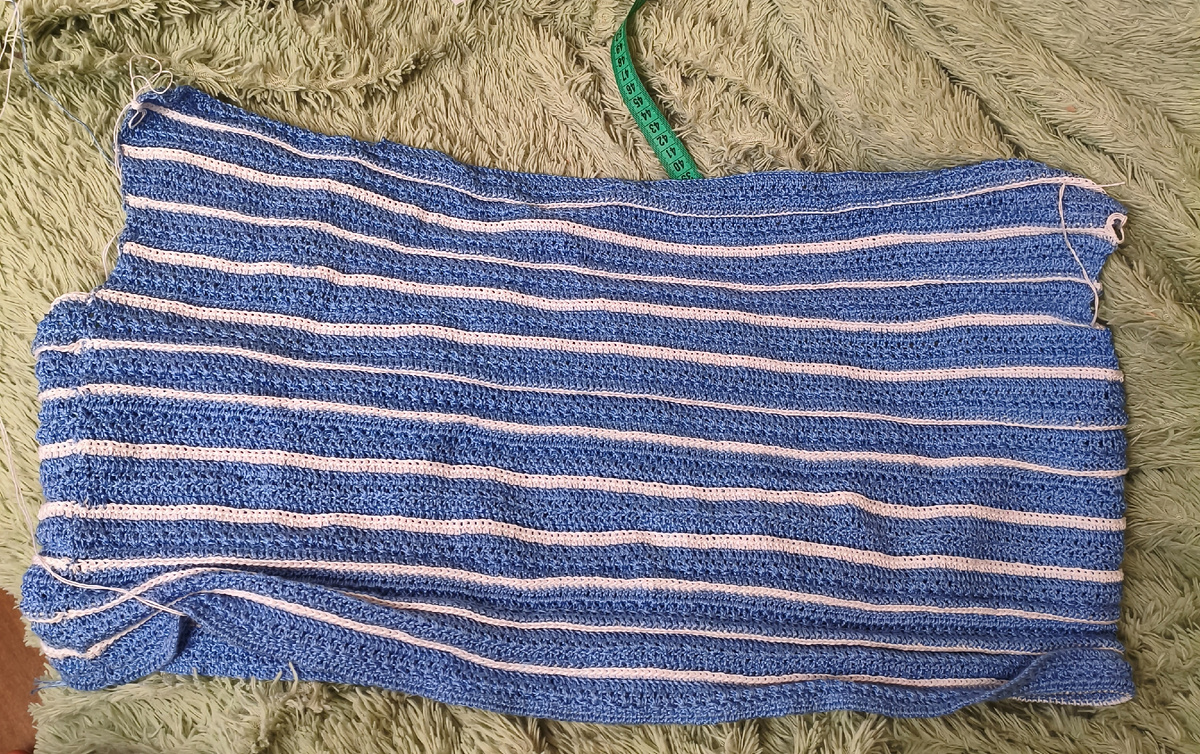 Тут вяжу снизу, приближаюсь к скосу плеча на спинке.