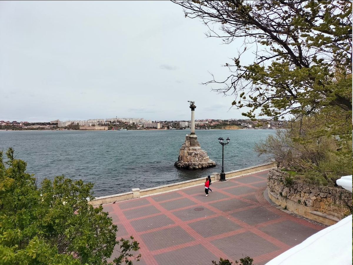 У моря пости никого и видно, что девушки в куртках с капюшонами. Вышли только ради того, чтобы сделать фото
