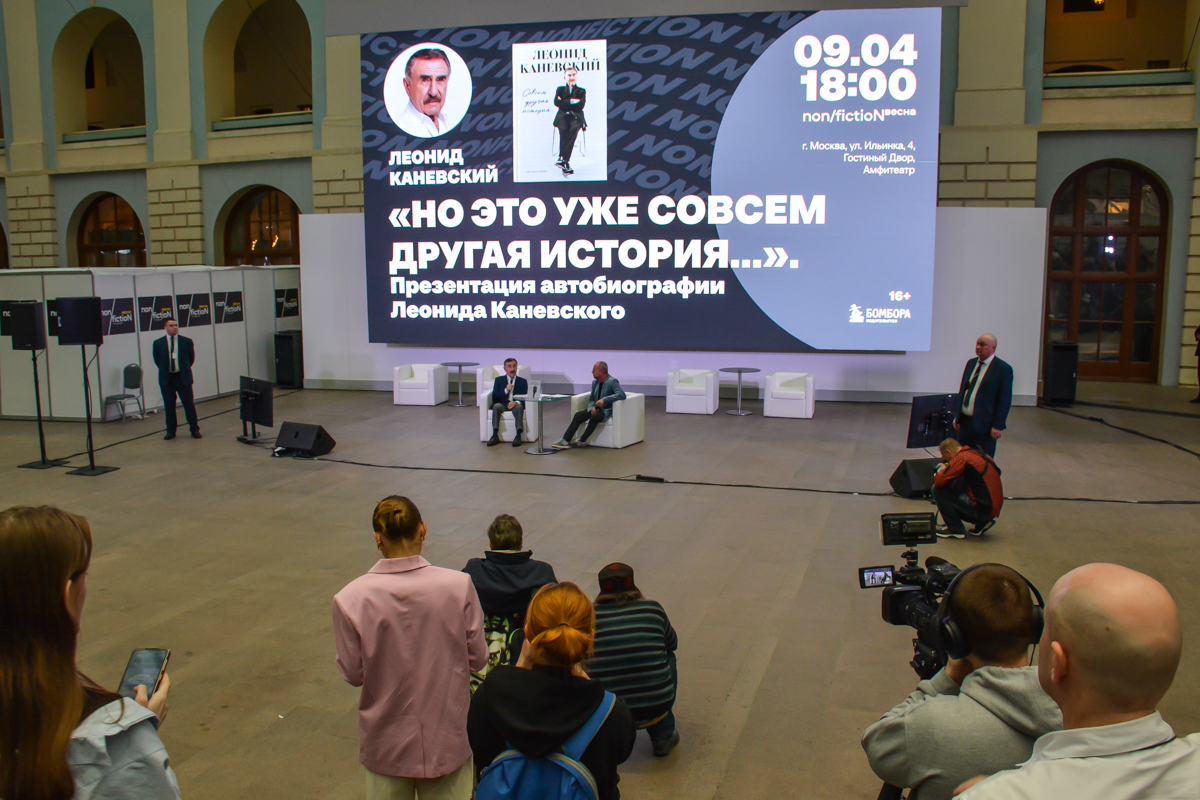 Леонид Каневский появился перед забитым амфитеатром Гостиного двора  под  бурные аплодисметнтыи в сопровождении двух охранников, которые расположились по обе стороны от  участников встречи.
