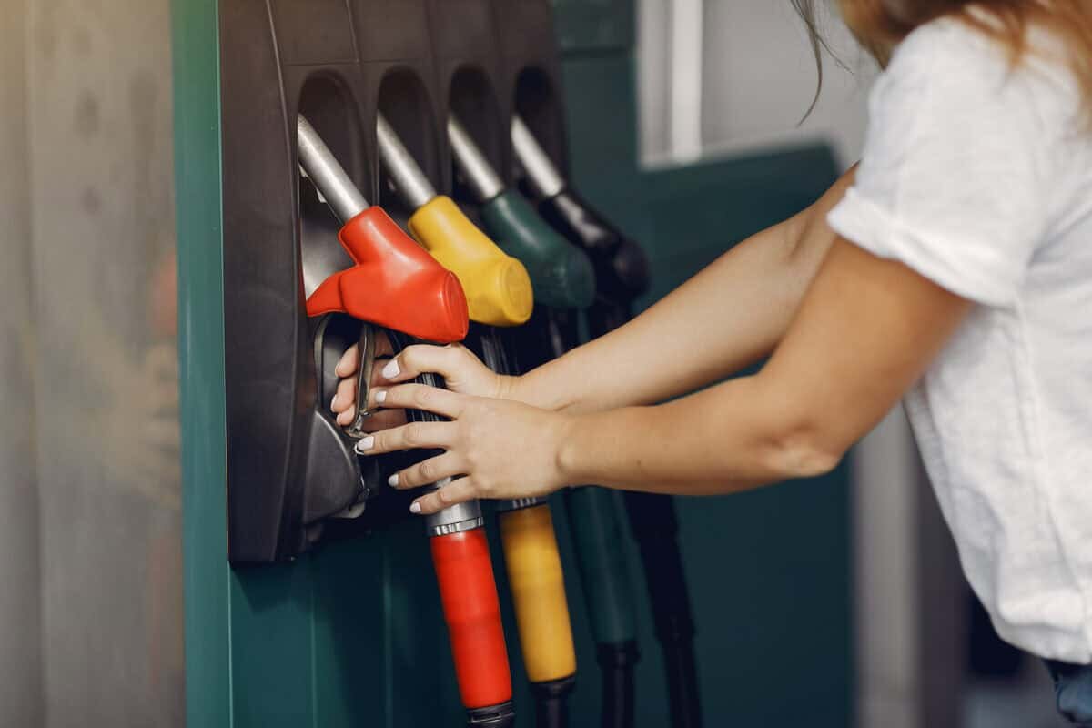    Woman on a gas station. Lady in a white t-shirt. Woman near the car. Александр Петров