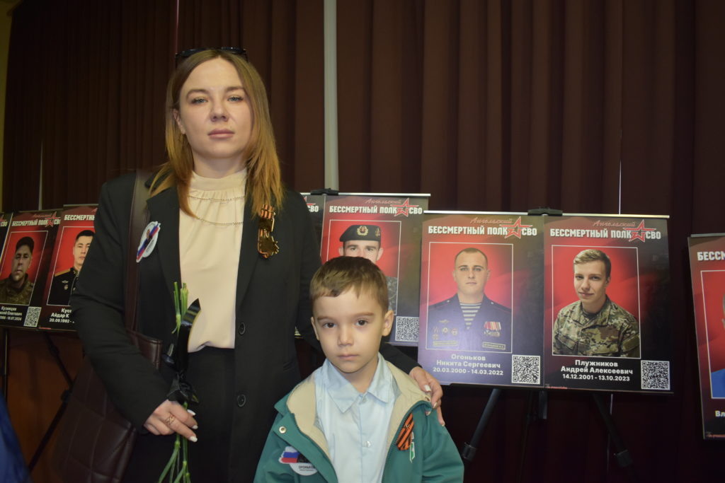     Супруга и сын героически погибшего при выполнении воинского долга в боях за город Мариуполь Никиты Огонькова у его портрета. Фото «ТАМАНЬ»