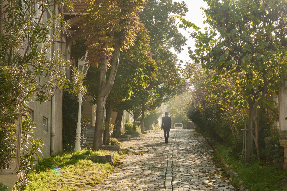    Old Istanbul street with a cobblestone on a sunny day, a man walks down the street, Turkey