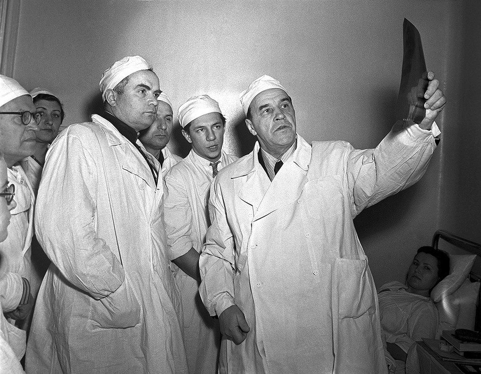    1955 год. Советский ученый-хирург, президент Академии медицинских наук СССР Александр Николаевич Бакулев (справа) во время осмотра больных вместе с участниками XXVI съезда хирургов. Фото: Александр Батанов, Лев Портер/ТАСС