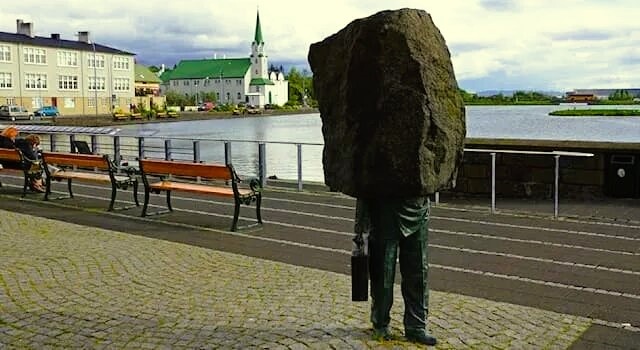 «Памятник неизвестному бюрократу» (Monument to the Unknown Bureaucrat). Она расположена в Рейкьявике.  Каменная глыба может символизировать то, как повседневная жизнь «рушится на нас», а безликий чиновник — быть «винтиком в колесе» системы. 
