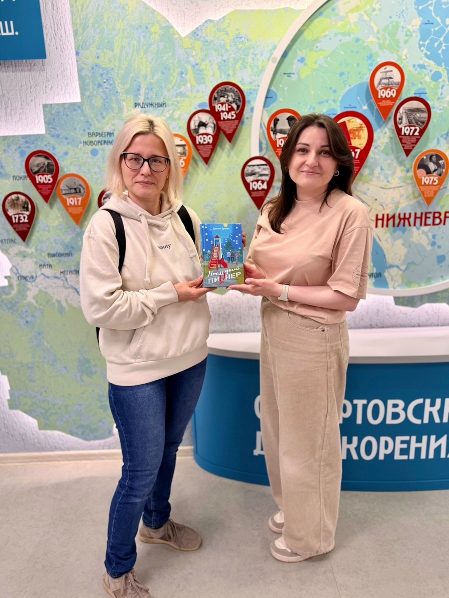 Вручение приза победительнице представителем библиотеки. Евгения Батталова слева:)