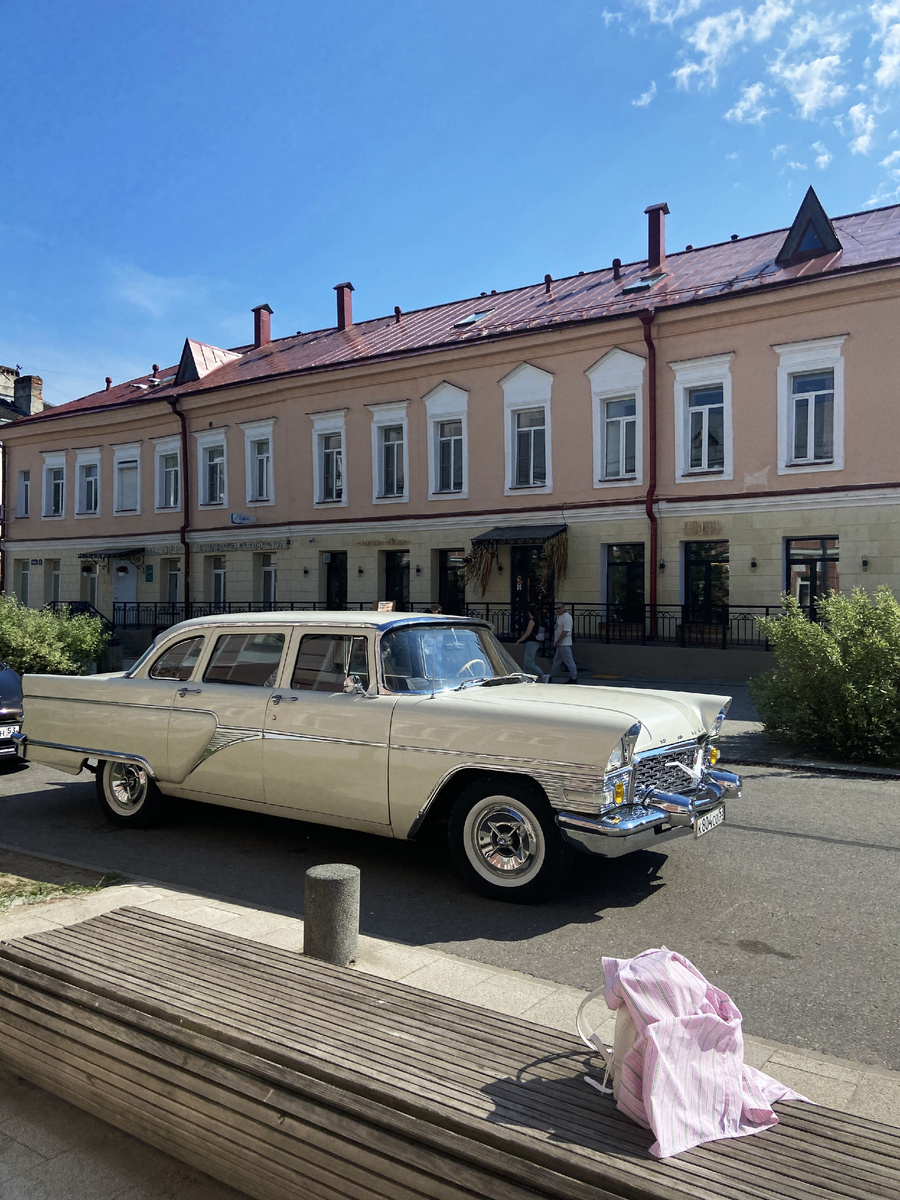 Раритное авто, а за ним видно вход в ресторан "Гусли".